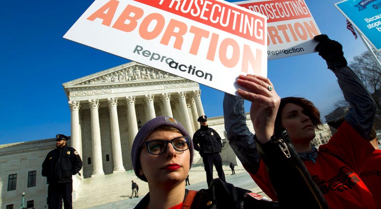 In this Jan. 18, 2019, file photo, abortion rights activists protest outside of the U.S. Supreme Court, during the March for Life in Washington. (AP Photo/Jose Luis Magana, File)