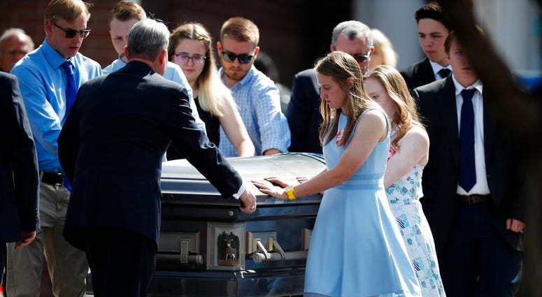 Pallbearers guide the casket of Kendrick Castillo
