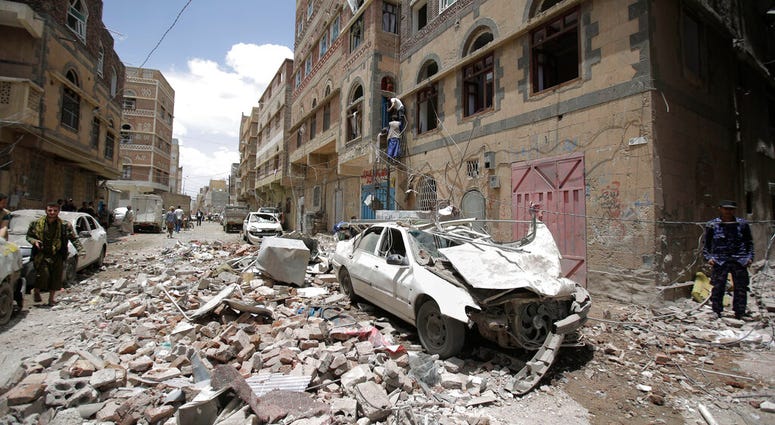 People inspect the site of an airstrike by Saudi-led coalition in Sanaa, Yemen, Thursday, May, 16, 2019. (AP Photo/Hani Mohammed)