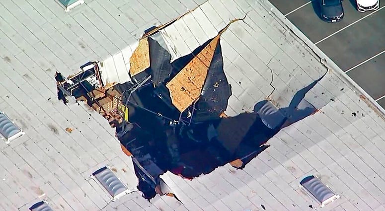 Hole in roof of warehouse where jet crashed