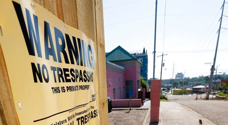 A "No Trespassing" sign is posted along the fencing protecting the parking lot of the Jackson Women's Health Organization, Friday, May 17, 2019, in Jackson, Miss. The facility is the state's only abortion clinic.(AP Photo/Rogelio V. Solis)