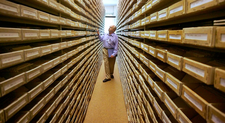 -FILE- In this May 8, 2008 file picture Gary Mokotoff, a Jewish genealogist from New Jersey, takes a look at name registers at the International Tracing Service in Bad Arolsen, central Germany. (AP Photo/Michael Probst, file) -FILE- In this May 8, 2008 file picture Gary Mokotoff, a Jewish genealogist from New Jersey, takes a look at name registers at the International Tracing Service in Bad Arolsen, central Germany. (AP Photo/Michael Probst, file)