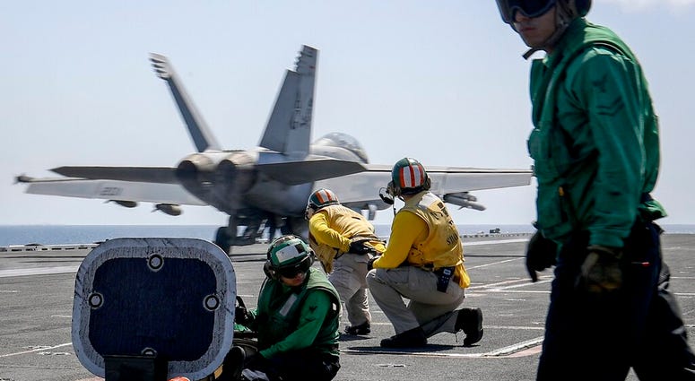In this Monday, May 20, 2019 photo, released by U.S. Navy, an F/A-18E Super Hornet from the "Jolly Rogers" of Strike Fighter Squadron. (Mass Communication Specialist 3rd Class Jeff Sherman/U.S. Navy via AP) In this Monday, May 20, 2019 photo, released by U.S. Navy, an F/A-18E Super Hornet from the "Jolly Rogers" of Strike Fighter Squadron. (Mass Communication Specialist 3rd Class Jeff Sherman/U.S. Navy via AP)