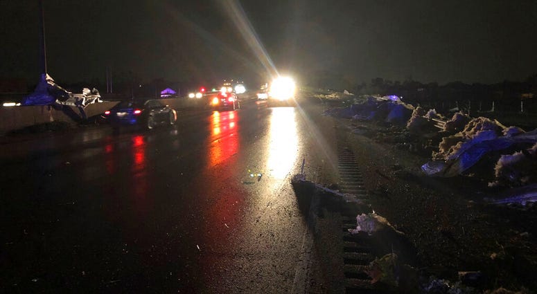 Ohio workers clearing roadway of storm debris