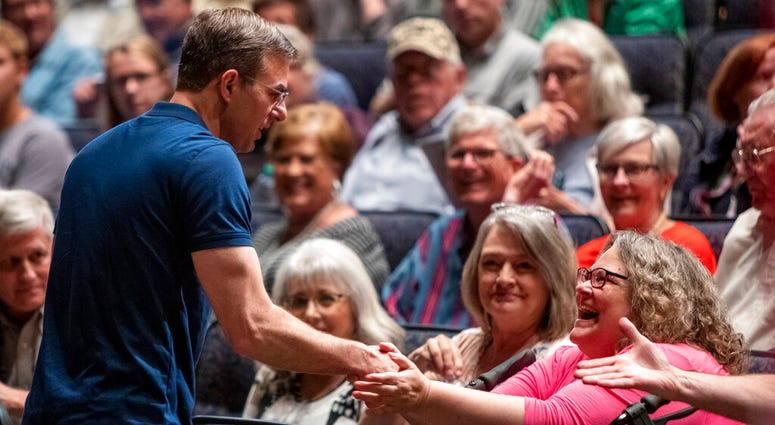 U.S. Rep. Justin Amash, R-Cascade Township, greets the crowd before holding a town hall meeting at Grand Rapids Christian High School's DeVos Center for Arts and Worship on Tuesday, May 28, 2019. (Cory Morse/The Grand Rapids Press via AP)