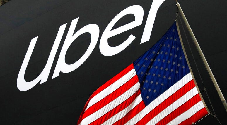 FILE - In this May 10, 2019, file phtoo a banner for Uber is draped on the front of the New York Stock Exchange before the world's largest ride-hailing service holds its initial public offering. (AP Photo/Mark Lennihan, File) FILE - In this May 10, 2019, file phtoo a banner for Uber is draped on the front of the New York Stock Exchange before the world's largest ride-hailing service holds its initial public offering. (AP Photo/Mark Lennihan, File)
