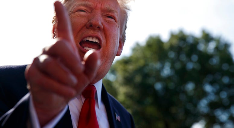President Donald Trump talks with reporters before departing on Marine One for the Air Force Academy graduation ceremony, Thursday, May 30, 2019, in Washington. (AP Photo/Evan Vucci)