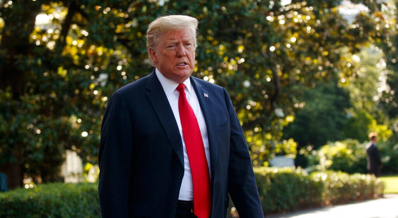 In this Thursday, May 30, 2019, file photo, President Donald Trump talks with reporters before departing on Marine One, in Washington. (AP Photo/Evan Vucci, File)