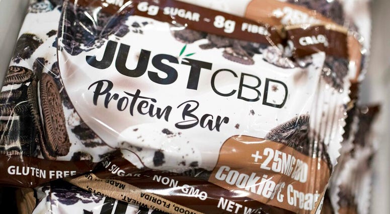 A cookies and cream flavored protein bar marketed by JustCBD is displayed at the Cannabis World Congress & Business Exposition trade show, Thursday, May 30, 2019 in New York. (AP Photo/Mark Lennihan)