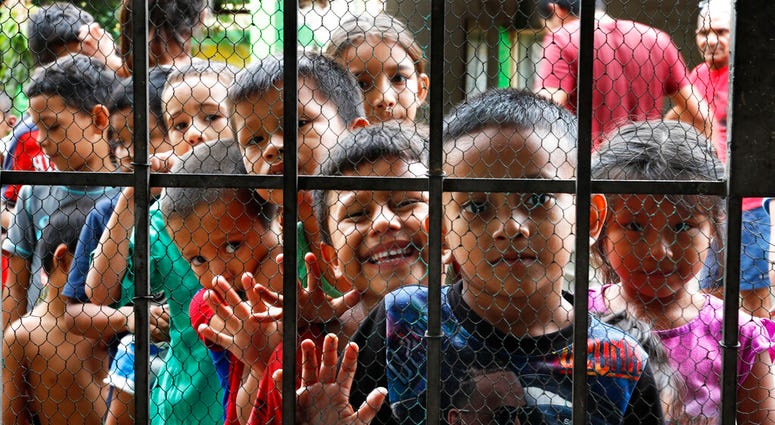 Migrant children line up for a meal at the door of the Jesus del Buen Pastor del Pobre y el Migrante shelter, in Tapachula, Chiapas state, Mexico, Thursday, May 30, 2019. Resentment has been growing in parts of central Mexico as the flow of migrants has c