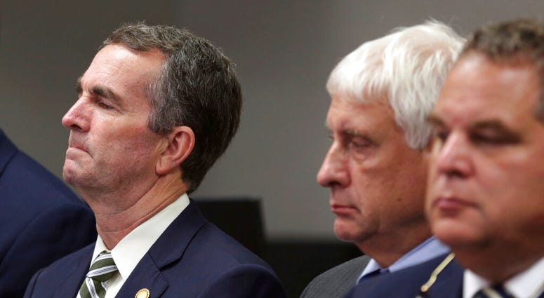 Gov. Ralph Northam, center, attends a vigil held to honor the lives lost in a mass shooting Saturday, June 1, 2019 in Virginia Beach. (Kristen Zeis/The Virginian-Pilot via AP)