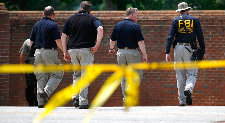 Investigators Work the Scene The FBI works outside an entrance to a municipal building that was the scene of a shooting,