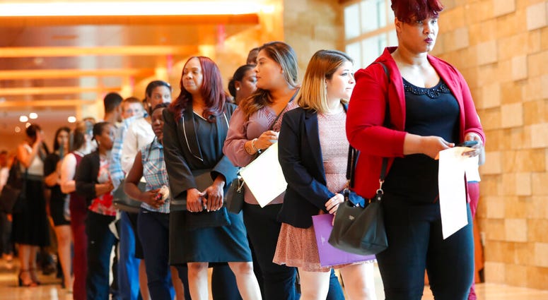 In this Tuesday, June 4, 2019 photo, job applicants line up at the Seminole Hard Rock Hotel & Casino Hollywood during a job fair in Hollywood, Fla. On Friday, July 5, the U.S. government issues the June jobs report. (AP Photo/Wilfredo Lee)