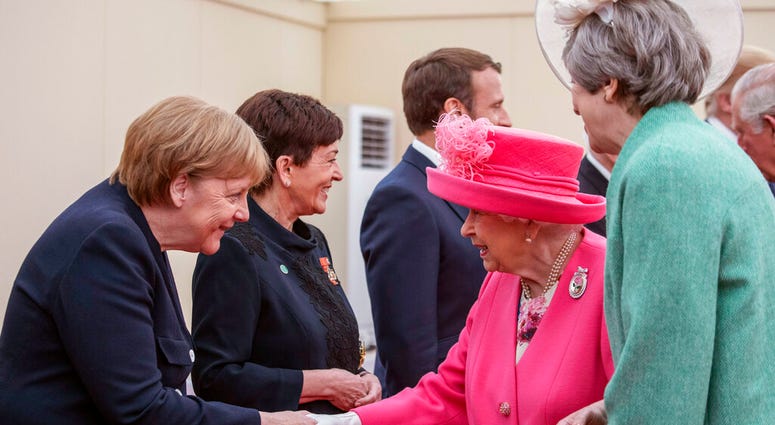 Germany's Angela Merkel shaking hands with Queen Elizabeth