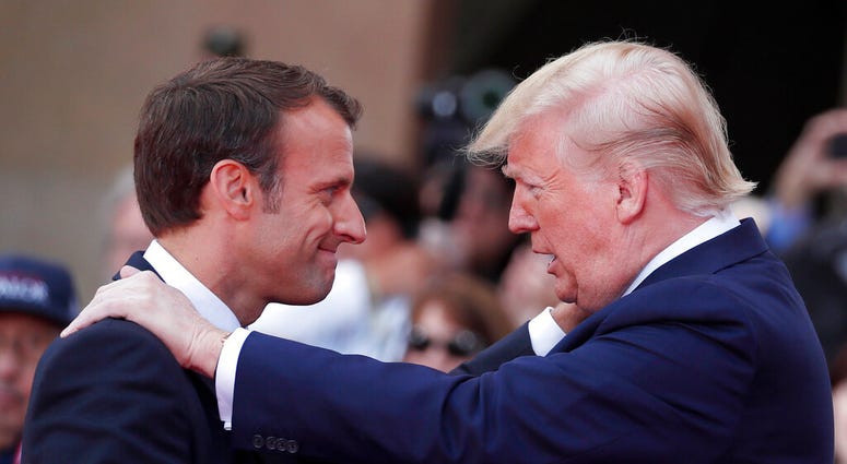 French President Emmanuel Macron, left, meets U.S President Donald Trump during a ceremony to mark the 75th anniversary of D-Day at the Normandy American Cemetery in Colleville-sur-Mer, Normandy, France. (Ian Langsdon/POOL via AP) French President Emmanuel Macron, left, meets U.S President Donald Trump during a ceremony to mark the 75th anniversary of D-Day at the Normandy American Cemetery in Colleville-sur-Mer, Normandy, France. (Ian Langsdon/POOL via AP)