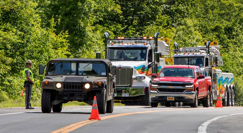 Military police direct traffic along Route 293 near the site where an armored personnel vehicle overturned killing at least one person. (AP Photo/Allyse Pulliam) Military police direct traffic along Route 293 near the site where an armored personnel vehicle overturned killing at least one person. (AP Photo/Allyse Pulliam)