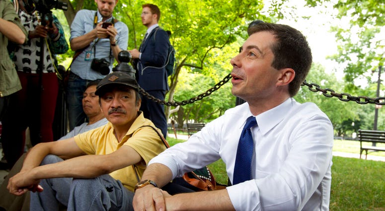 Democratic presidential candidate Mayor Pete Buttigieg, right, attends a rally protesting against President Donald Trump policies outside of the White House in Washington, Wednesday, June 12, 2019. (AP Photo/Jose Luis Magana)