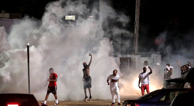 Frayser community residents taunt authorities as protesters take to the streets in anger against the shooting of a youth identified by family members as Brandon Webber by U.S. Marshals on June 12, 2019, in Memphis, Tenn. (Jim Weber/Daily Memphian via AP)