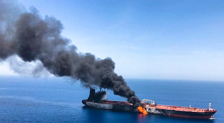 Smoke rising from a tanker in Sea of Oman