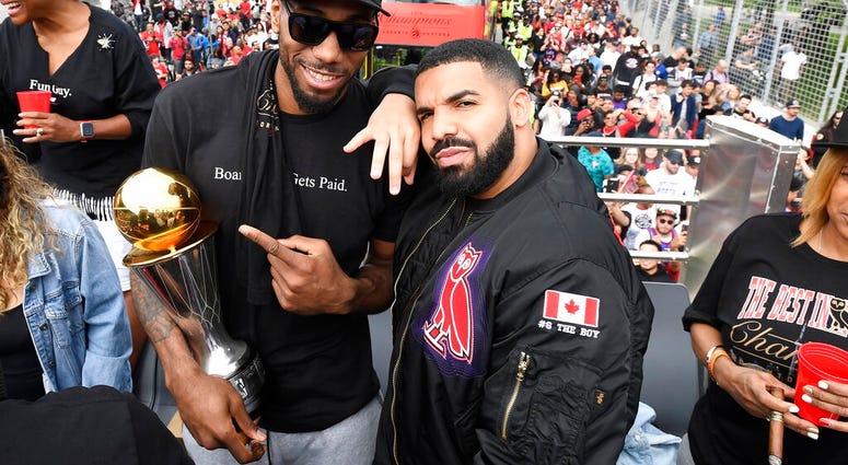 Toronto Raptors forward Kawhi Leonard points at his playoffs MVP trophy as he poses with performing artist Drake during the 2019 Toronto Raptors NBA basketball championship parade. (Frank Gunn/The Canadian Press via AP) Toronto Raptors forward Kawhi Leonard points at his playoffs MVP trophy as he poses with performing artist Drake during the 2019 Toronto Raptors NBA basketball championship parade. (Frank Gunn/The Canadian Press via AP)