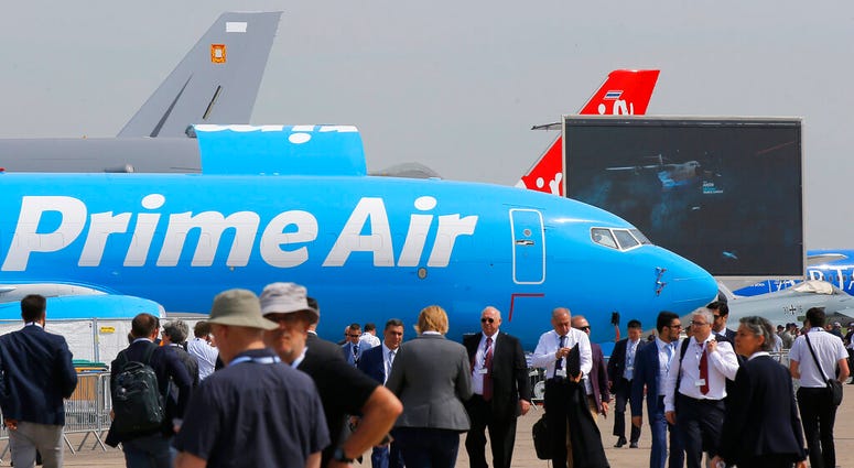 Visitors walk past an Boeing 737-800 BCF Amazon "Prime Air" cargo plane at Paris Air Show, in Le Bourget, east of Paris, France, Tuesday, June 18, 2019. (AP Photo/Michel Euler) Visitors walk past an Boeing 737-800 BCF Amazon "Prime Air" cargo plane at Paris Air Show, in Le Bourget, east of Paris, France, Tuesday, June 18, 2019. (AP Photo/Michel Euler)
