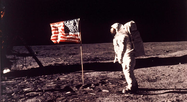 FILE - In this image provided by NASA, astronaut Buzz Aldrin poses for a photograph beside the U.S. flag deployed on the moon during the Apollo 11 mission on July 20, 1969. A new poll shows most Americans prefer focusing on potential asteroid impacts over