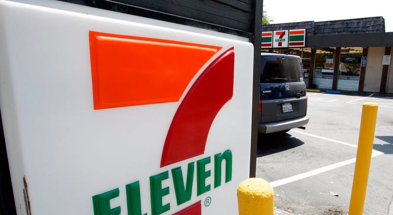 FILE - In this July 1, 2008 file photo, a 7-Eleven is shown in Palo Alto, Calif. The convenience-store chain is launching a service that lets customers order everything from its trademark frozen drink to a battery charger and have it delivered to a public
