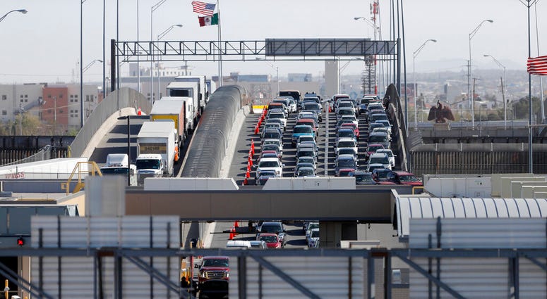 FILE - In this March 29, 2019, file photo, cars and trucks line up to enter the U.S. from Mexico at a border crossing in El Paso, Texas. Authorities in far South Texas say U.S. Border Patrol agents have discovered the bodies of four people, including thre