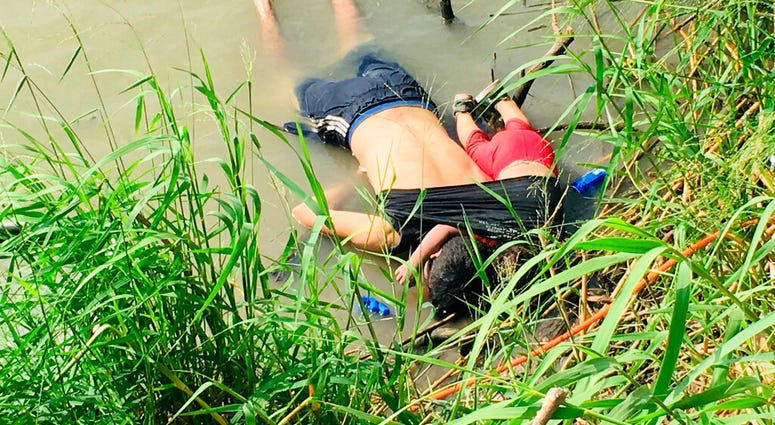 The bodies of Salvadoran migrant Oscar Alberto Martínez Ramírez and his nearly 2-year-old daughter Valeria lie on the bank of the Rio Grande in Matamoros, Mexico, Monday, June 24, 2019, after they drowned trying to cross the river. (AP Photo/Julia Le Duc)