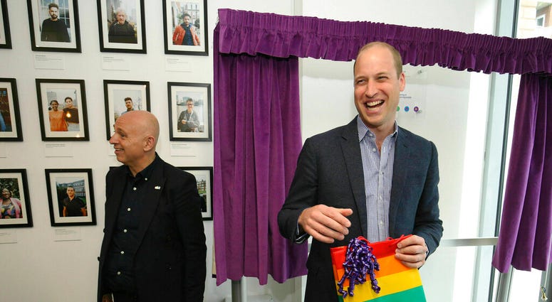 Britain's Prince William, the Duke of Cambridge, reacts to receiving a gift bag from trust chief executive officer Tim Sigsworth, during a visit to the Albert Kennedy Trust. (Jonathan Brady/Pool Photo via AP) Britain's Prince William, the Duke of Cambridge, reacts to receiving a gift bag from trust chief executive officer Tim Sigsworth, during a visit to the Albert Kennedy Trust. (Jonathan Brady/Pool Photo via AP)