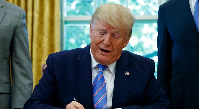 President Donald Trump signs a $4.6 billion aid package to help the federal government cope with the surge of Central American immigrants at the U.S.-Mexico border. (AP Photo/Carolyn Kaster) President Donald Trump signs a $4.6 billion aid package to help the federal government cope with the surge of Central American immigrants at the U.S.-Mexico border. (AP Photo/Carolyn Kaster)