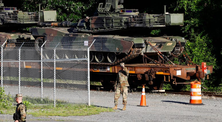 Military police walk near Abrams tanks on a flat car in a rail yard, Monday, July 1, 2019, in Washington, ahead of a Fourth of July celebration that President Donald Trump says will include military hardware. (AP Photo/Patrick Semansky) Military police walk near Abrams tanks on a flat car in a rail yard, Monday, July 1, 2019, in Washington, ahead of a Fourth of July celebration that President Donald Trump says will include military hardware. (AP Photo/Patrick Semansky)