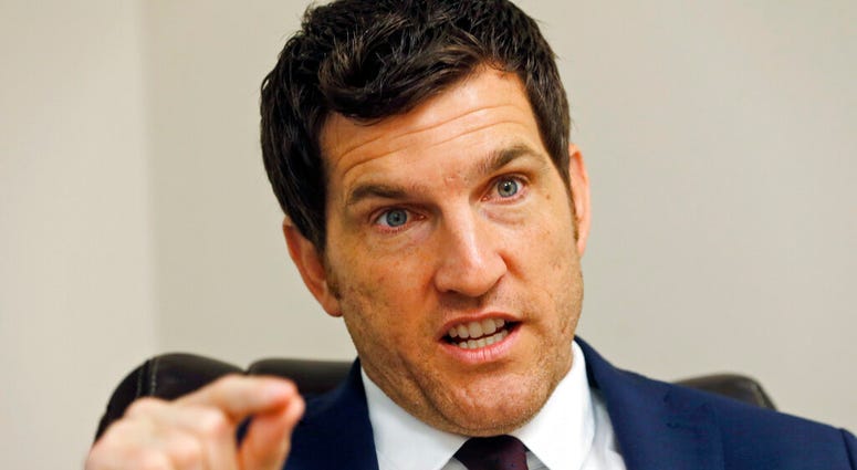 FILE - In this Friday, Oct. 7, 2016, file photo, then Virginia's 2nd District Congressman Scott Taylor speaks during an interview in his campaign office in Virginia Beach, Va. Taylor says he’s running for U.S. Senate in Virginia, hoping to unseat Democrat