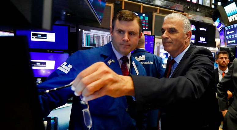 Israel's Finance Minister Moshe Kahlon, right, meets with specialist Thomas Schreck during a visit to the New York Stock Exchange trading floor, Monday, July 8, 2019. (AP Photo/Richard Drew)