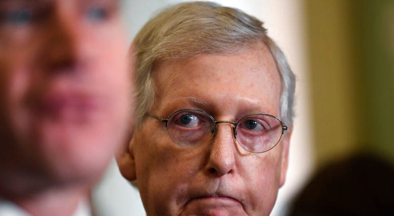 Senate Majority Leader Mitch McConnell of Ky., right, listens as Sen. Todd Young, R-Ind., left, speaks to reporters following the weekly policy luncheon on Capitol Hill in Washington, Tuesday, July 9, 2019. (AP Photo/Susan Walsh) Senate Majority Leader Mitch McConnell of Ky., right, listens as Sen. Todd Young, R-Ind., left, speaks to reporters following the weekly policy luncheon on Capitol Hill in Washington, Tuesday, July 9, 2019. (AP Photo/Susan Walsh)