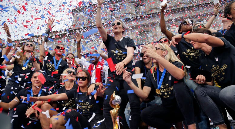 The U.S. women's soccer team, Megan Rapinoe center, celebrates at City Hall after a ticker tape parade, Wednesday, July 10, 2019, in New York. (AP Photo/Seth Wenig) The U.S. women's soccer team, Megan Rapinoe center, celebrates at City Hall after a ticker tape parade, Wednesday, July 10, 2019, in New York. (AP Photo/Seth Wenig)