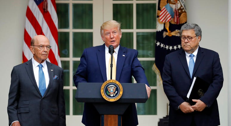 President Donald Trump is joined by Commerce Secretary Wilbur Ross and Attorney General William Barr, right, as he speaks in the Rose Garden at the White House in Washington, Thursday, July 11, 2019. (AP Photo/Carolyn Kaster)