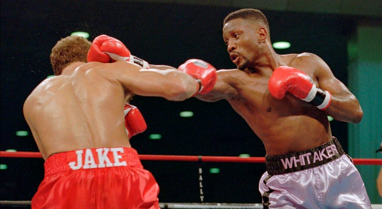 In this Nov. 18, 1995, file photo, WBC welterweight champion Pernell "Sweet Pea" Whitaker, right, delivers a right to the head of challenger Jake Rodriguez during their scheduled 12 round bout in Atlantic City, N.J. (AP Photo/Donna Connor, File)