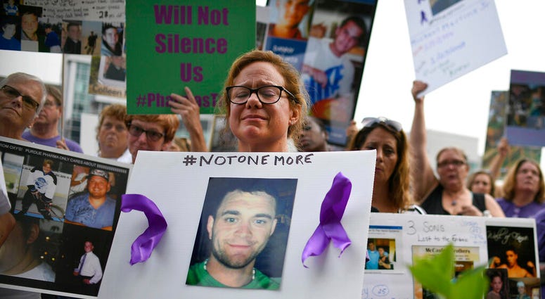 Christine Gagnon, of Southington, Conn., holds a sign during a protest with others who have lost loved ones to OxyContin and opioid overdoses, outside the Purdue Pharma headquarters in Stamford, Conn. (AP Photo/Jessica Hill, File) Christine Gagnon, of Southington, Conn., holds a sign during a protest with others who have lost loved ones to OxyContin and opioid overdoses, outside the Purdue Pharma headquarters in Stamford, Conn. (AP Photo/Jessica Hill, File)