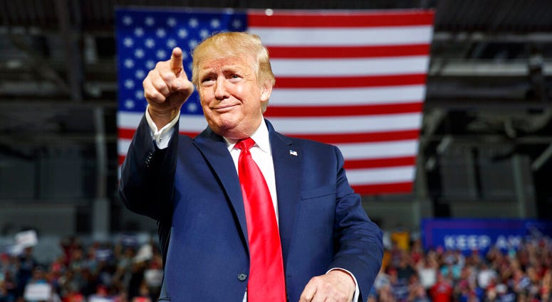 President Donald Trump gestures to the crowd as he arrives to speak at a campaign rally at Williams Arena in Greenville, N.C., Wednesday, July 17, 2019. (AP Photo/Carolyn Kaster)