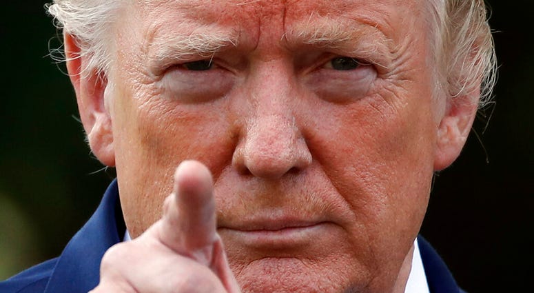 President Donald Trump points to a reporter for a questions as he speaks with reporters on the South Lawn of the White House before departing, Friday, July 19, 2019, in Washington. (AP Photo/Alex Brandon)