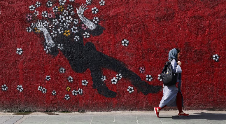 A woman walks past a mural in a sidewalk in downtown Tehran, Iran, Sunday, July 21, 2019. (AP Photo/Vahid salemi) A woman walks past a mural in a sidewalk in downtown Tehran, Iran, Sunday, July 21, 2019. (AP Photo/Vahid salemi)
