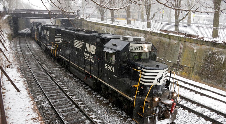 FILE - In this March 3, 2019, file photo a Norfolk Southern freight train passes through the Northside of Pittsburgh as show begins to fall. Norfolk Southern Corp. reports earning on Wednesday, July 24. (AP Photo/Gene J. Puskar, File) FILE - In this March 3, 2019, file photo a Norfolk Southern freight train passes through the Northside of Pittsburgh as show begins to fall. Norfolk Southern Corp. reports earning on Wednesday, July 24. (AP Photo/Gene J. Puskar, File)