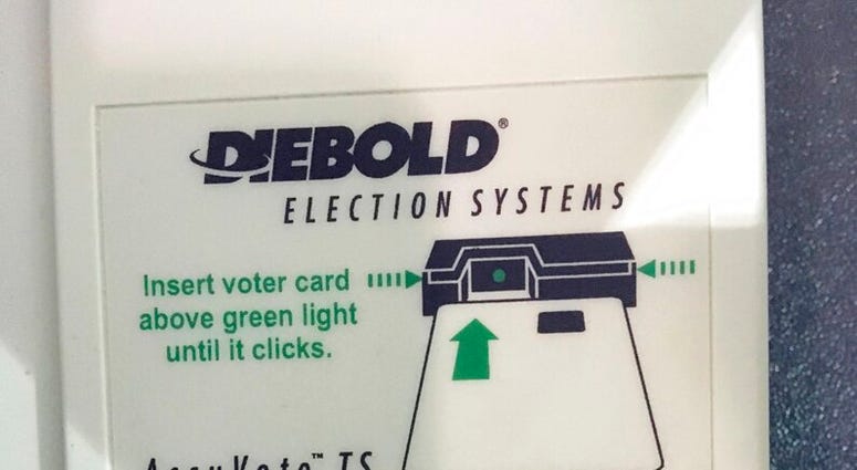 FILE - This May 22, 2018, file photo, shows a voter access card inserted in a reader during voting in the Georgia primary in Kennesaw, Ga. A federal judge is set to hear arguments, Thursday, July 25, 2019, in a lawsuit challenging Georgia's outdated votin