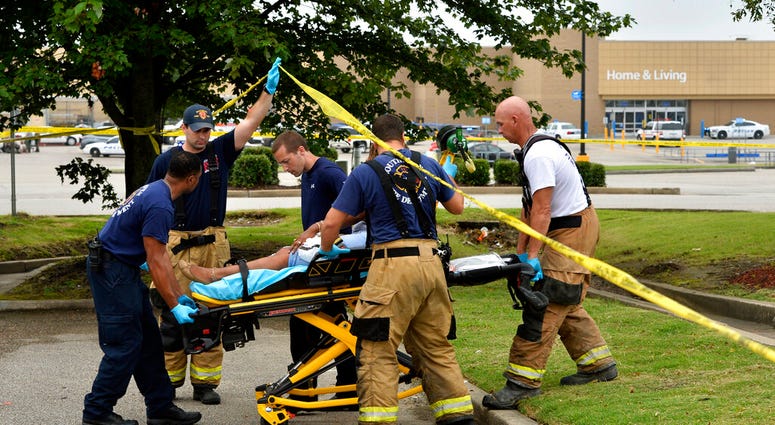Paramedics offer medical attention after a shooting at a Walmart store Tuesday, July 30, 2019 in Southaven, Miss. (AP Photo/Brandon Dill)