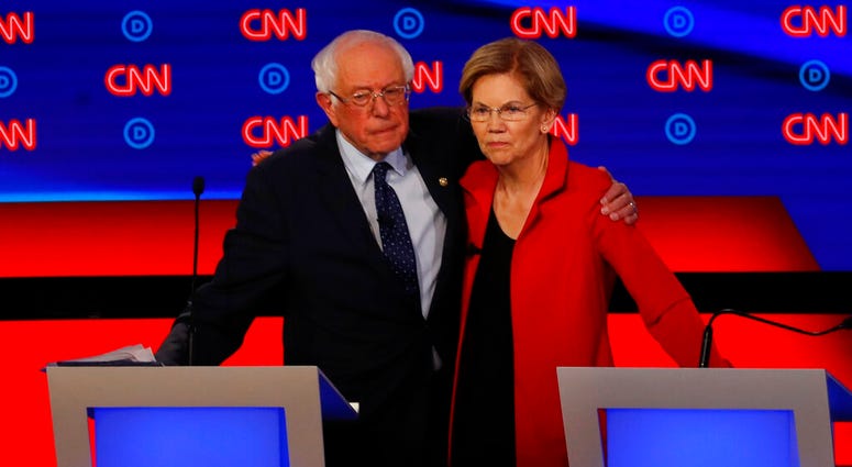 Sen. Bernie Sanders, I-Vt., and Sen. Elizabeth Warren, D-Mass., embrace after the first of two Democratic presidential primary debates hosted by CNN Tuesday, July 30, 2019, in the Fox Theatre in Detroit. (AP Photo/Paul Sancya)