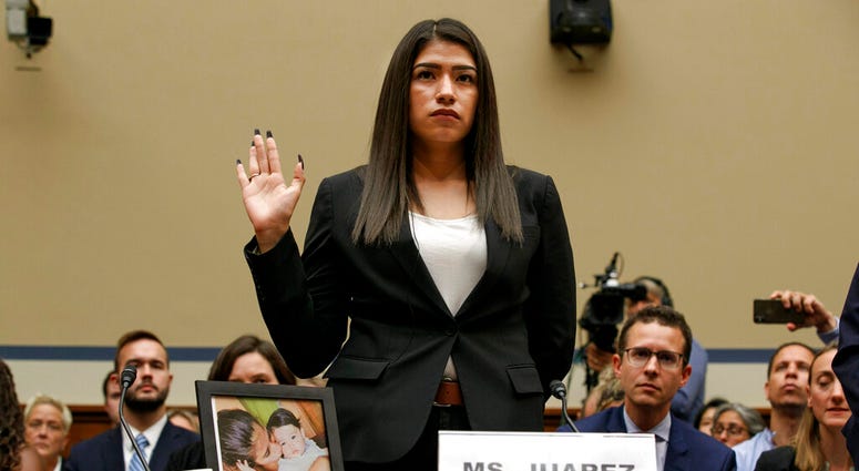 In this July 10, 2019, file photo, Yazmin Juarez, is sworn in by a photo of her holding her daughter Mariee, 1, who died after being released from detention by U.S. Immigration and Customs Enforcement. (AP Photo/Jacquelyn Martin, File)