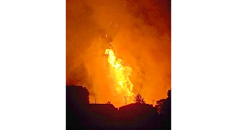 In this Thursday, Aug. 1, 2019 photo provided by Naomi Hayes, a fire burns after an explosion near Junction City, Ky. A regional gas pipeline ruptured early Thursday in Kentucky, causing a massive explosion that killed one person, hospitalized five others