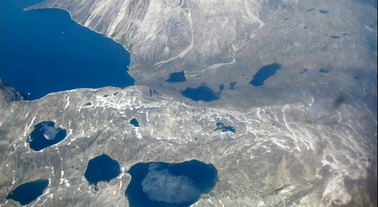 In this image taken on June 22, 2019 an aerial view of melt water lakes on the edge of an ice cap in Nunatarssuk, Greenland. (AP Photo/Sandy Virgo)