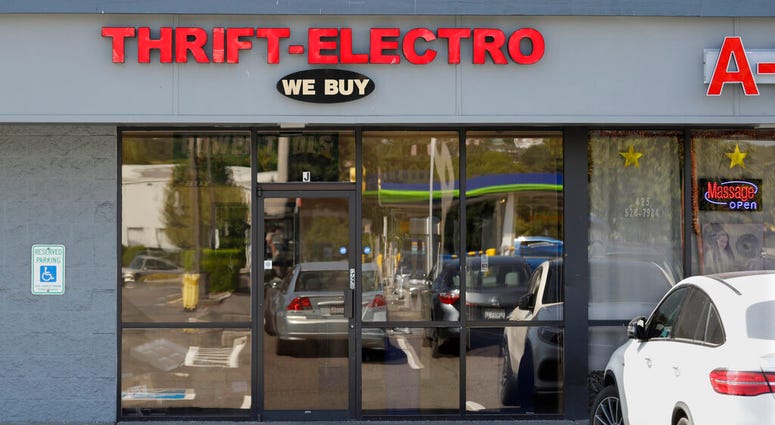 In this Wednesday, July 31, 2019, photo a pawn shop alleged to have been a front for a theft ring stands closed in Renton, Wash. The FBI says the ring sold millions of dollars' worth of stolen goods on Amazon.com in the past six years, and that a pair of